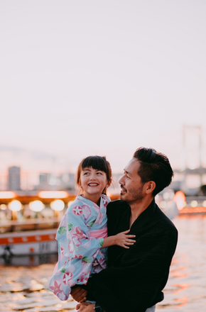 Japanese father and preschool daughter wearing kimono on boat, Tokyo - Getty Images
